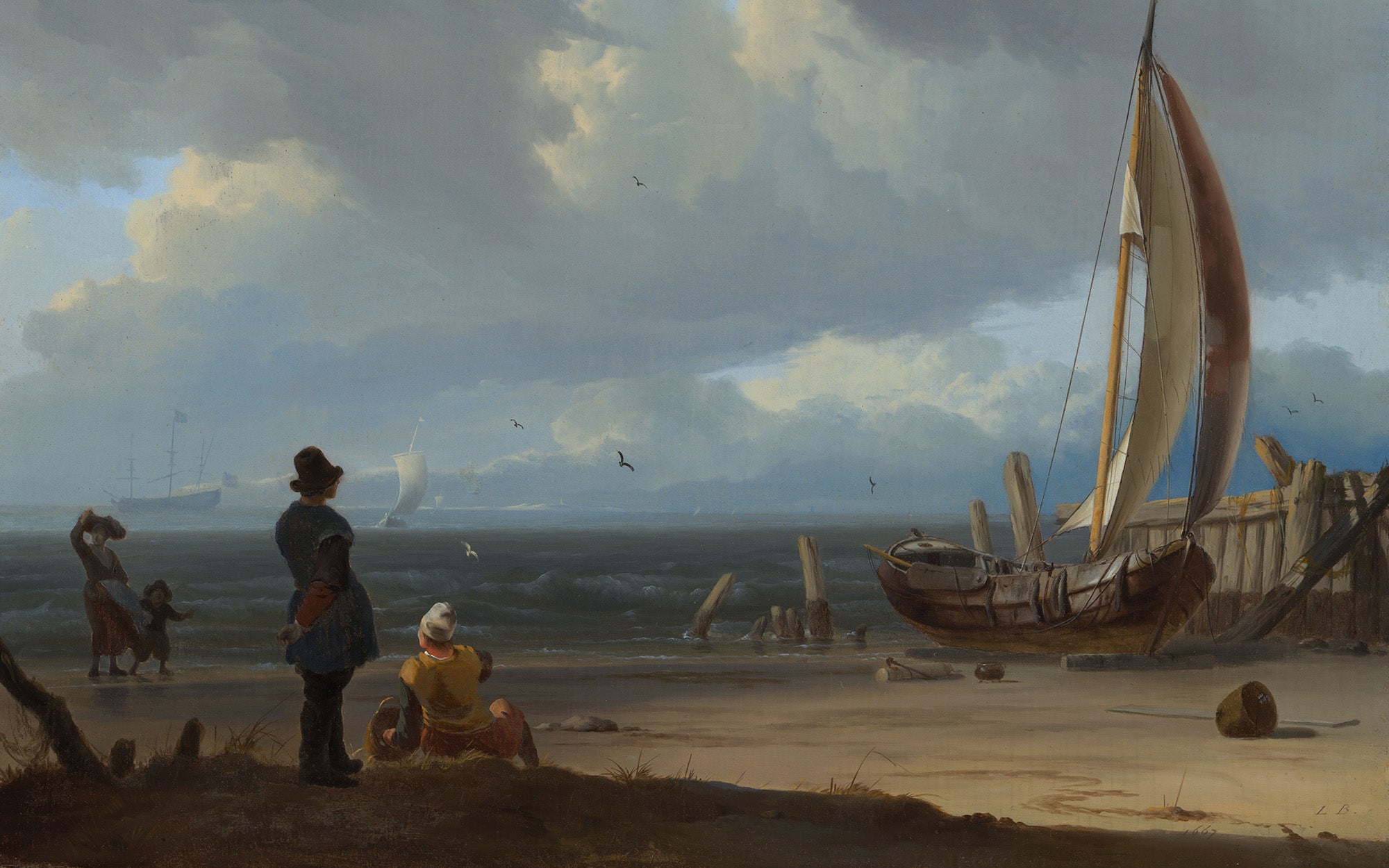 Zeegezicht met figuren bij een vissersboot op het strand